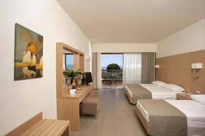 a hotel room with two beds and a balcony at Island Blue Hotel in Pefki Rhodes