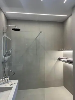 a bathroom with a shower with a glass door at Villa Stergos in Kremasti
