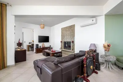 a living room with a couch and a fireplace at Villa Zafira - Seaview Manor with Heated Pool in Kallithea Rhodes