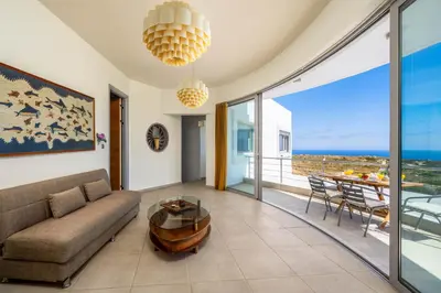a living room with a couch and a table at Villa Zafira - Seaview Manor with Heated Pool in Kallithea Rhodes