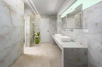 a white bathroom with two sinks and a mirror at Villa Zafira - Seaview Manor with Heated Pool in Kallithea Rhodes