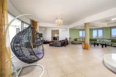 a living room with a hanging hammock at Villa Zafira - Seaview Manor with Heated Pool in Kallithea Rhodes