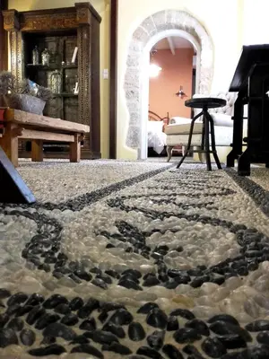 a room with a rug with rocks on the floor at Villa dei Ciottoli in Rhodes Town