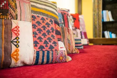 a row of colorful pillows sitting on a red carpet at Villa dei Ciottoli in Rhodes Town