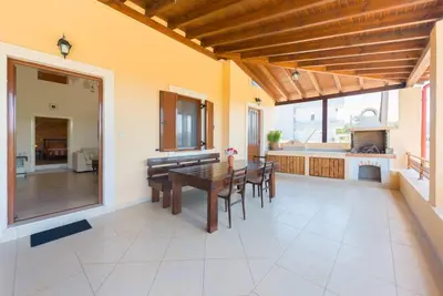 a dining room and kitchen with a table and chairs at Theologos Traditional House in Theologos