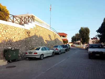 a group of cars parked next to a stone wall at Theologos Traditional House in Theologos