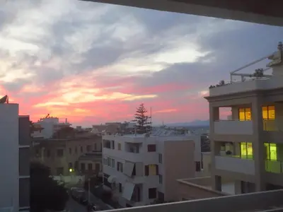 a view of a sunset from a balcony with buildings at Mini City Center Studio in Rhodes Town