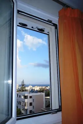 a window with a view of a city at Mini City Center Studio in Rhodes Town