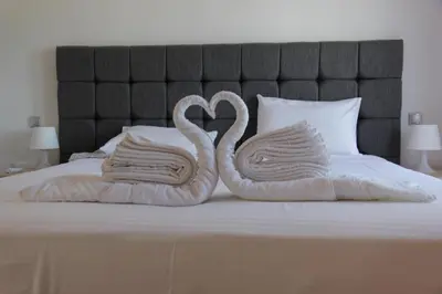 two swansuitsrendered to look like towels on a bed at Platoni Elite in Ialyssos