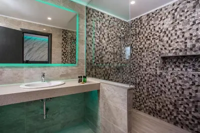 a bathroom with a sink and a mirror at Platoni Elite in Ialyssos