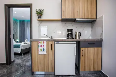 a kitchen with a sink and a refrigerator at Platoni Elite in Ialyssos