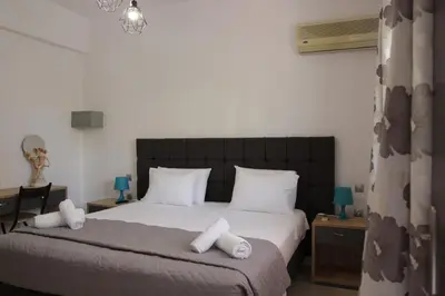 a bedroom with a bed with white towels on it at Platoni Elite in Ialyssos