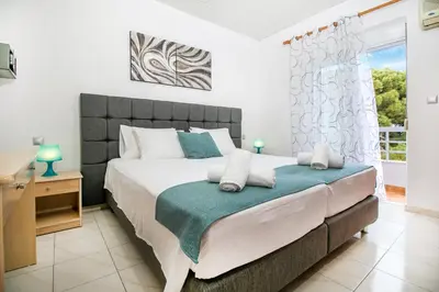 a bedroom with a large bed and a window at Platoni Elite in Ialyssos