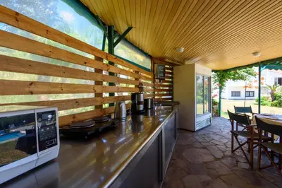 a kitchen with a counter with a wooden wall at Sutherlea in Koskinou
