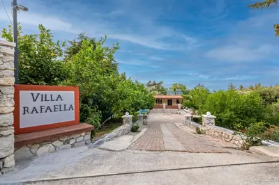 a sign for a villa with a road at Villa Rafaela in Koskinou