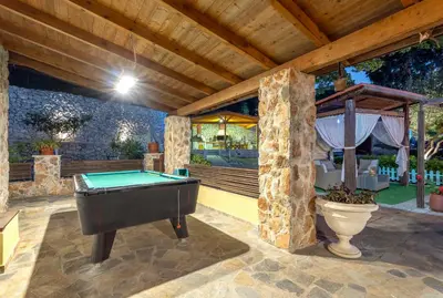 a patio with a pool table in a house at Villa Rafaela in Koskinou