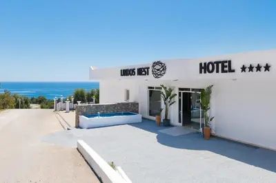 a hotel with a couch in front of a building at Lindos Nest in Pefki Rhodes