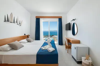 a bedroom with a bed with a stuffed animal on it at Lindos Nest in Pefki Rhodes