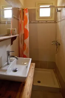 a bathroom with a sink and a shower at Mango Rooms in Rhodes Town