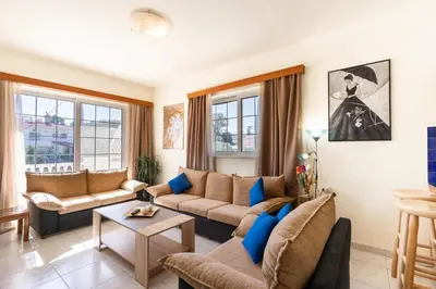 a living room with a couch and a table at COLONIAL FAMILY apartment #3 in Faliraki