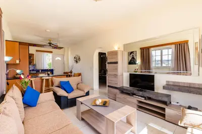 a living room with a couch and a table at COLONIAL FAMILY apartment #3 in Faliraki