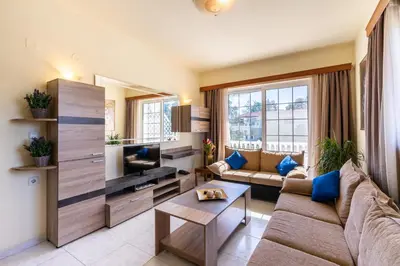 a living room with a couch and a tv at COLONIAL FAMILY apartment #3 in Faliraki