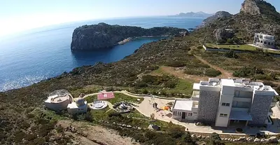 an aerial view of a house on a hill next to the ocean at Astronomy Studios in Faliraki