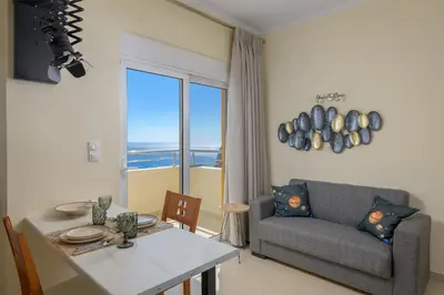 a living room with a couch and a table at Astronomy Studios in Faliraki