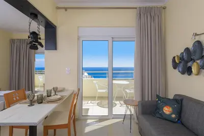 a living room with a view of the ocean at Astronomy Studios in Faliraki