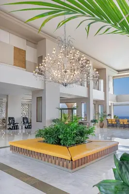 a large lobby with a chandelier and a large table at KRESTEN ROYAL Euphoria Resort in Kallithea Rhodes