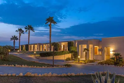 a rendering of a villa at night with palm trees at KRESTEN ROYAL Euphoria Resort in Kallithea Rhodes