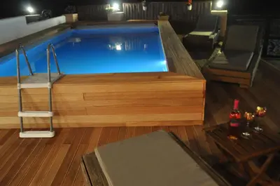 a large swimming pool with a wooden floor at Villa Imerti Kiotari in Kiotari