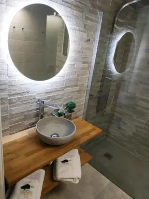 a bathroom with a sink and a mirror at Villa Imerti Kiotari in Kiotari