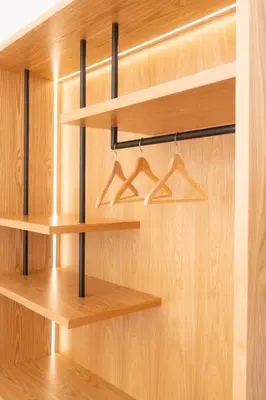 a closet with wooden shelves and hangers at Villa Antonis in Halki