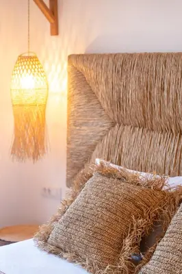 a chandelier hangs over a bed with a pillow at Villa Antonis in Halki