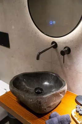 a stone sink sitting on a table in a bathroom at Villa Antonis in Halki
