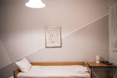 a bedroom with two beds and a picture on the wall at Pantheon Deluxe Apartments in Archangelos