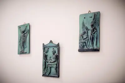 four pieces of art hanging on a wall at Pantheon Deluxe Apartments in Archangelos