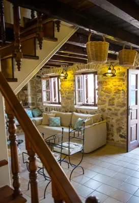 a living room with a couch and a table at Halkis Muses in Halki