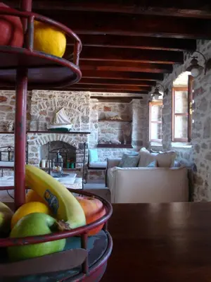 a table with a bunch of fruit in a room at Halkis Muses in Halki