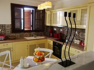 a kitchen with a bowl of fruit on a table at Halkis Muses in Halki