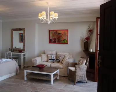 a living room with a couch and a table at Halkis Muses in Halki