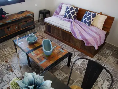 a living room with a couch and a table at Halkis Muses in Halki