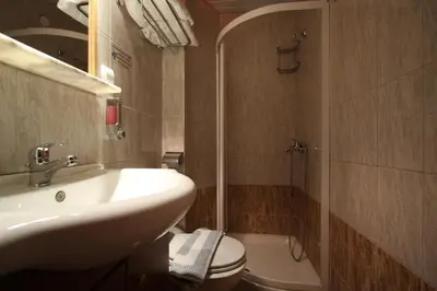 a bathroom with a sink and a toilet and a shower at Sofia Pension in Rhodes Town