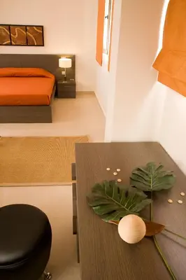 a bedroom with a bed and a table and a bed at Blue Dream Luxury Villas in Pefki Rhodes