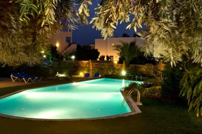 a swimming pool in a yard at night at Blue Dream Luxury Villas in Pefki Rhodes