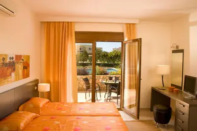 a hotel room with a bed and a sliding glass door at Blue Dream Luxury Villas in Pefki Rhodes