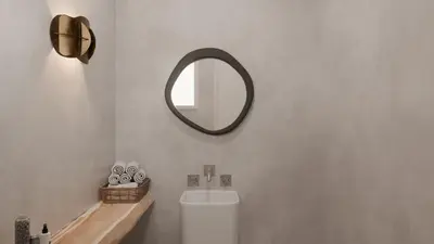 a bathroom with a mirror and a toilet and a sink at Aelia mini villa in Líndos