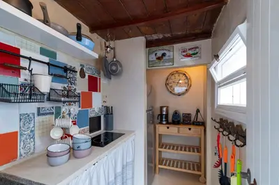 a kitchen with a counter with pots and pans on the wall at Aelia mini villa in Líndos