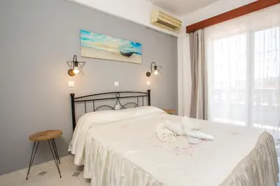 a bedroom with a bed with towels on it at Jack Daniel Friends in Faliraki